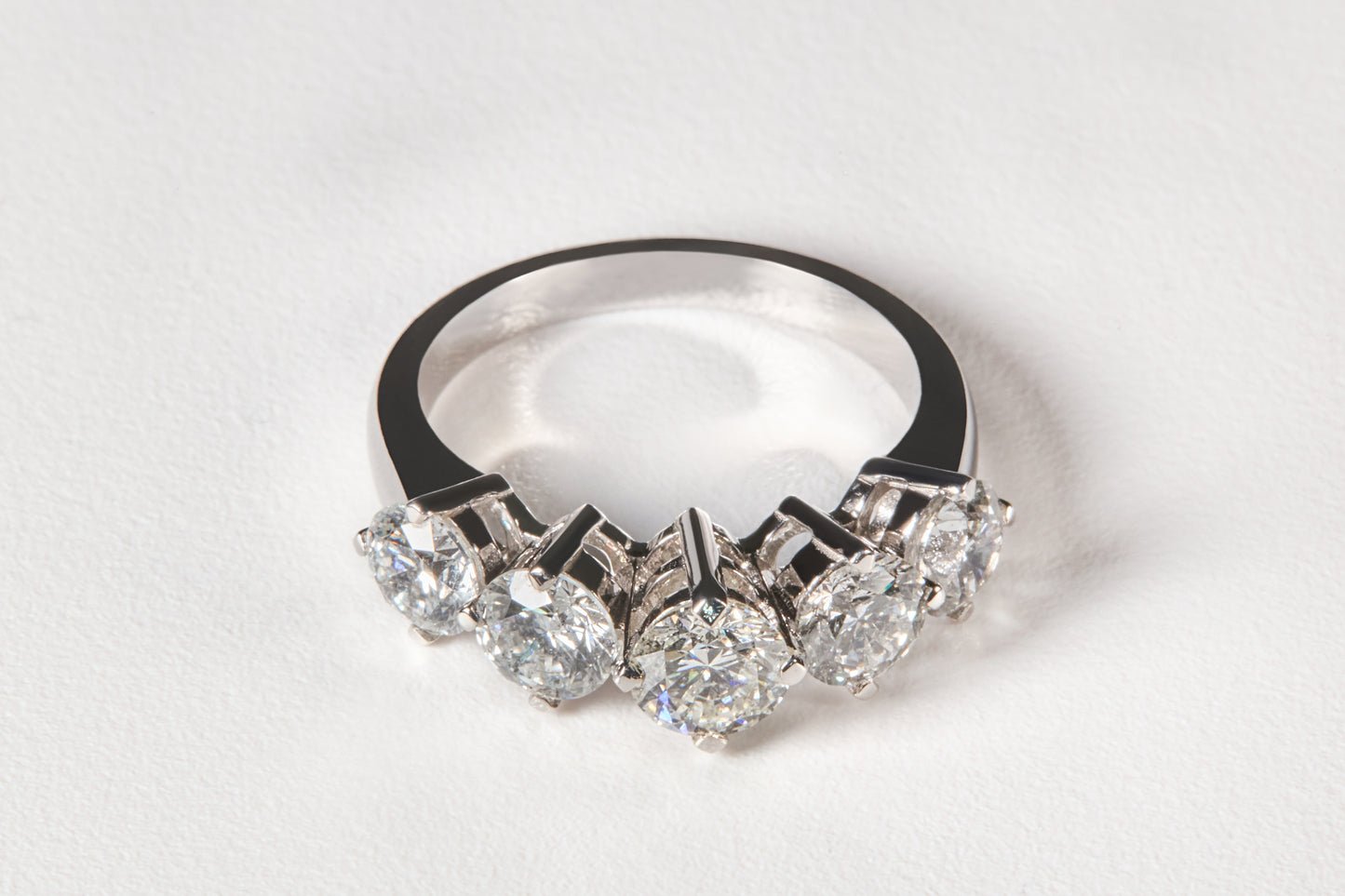 Silver diamond engagement wedding ring with multiple gemstones on a white background
