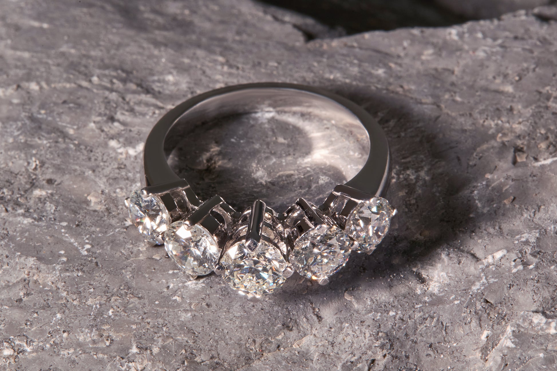 Diamond ring on a textured stone surface